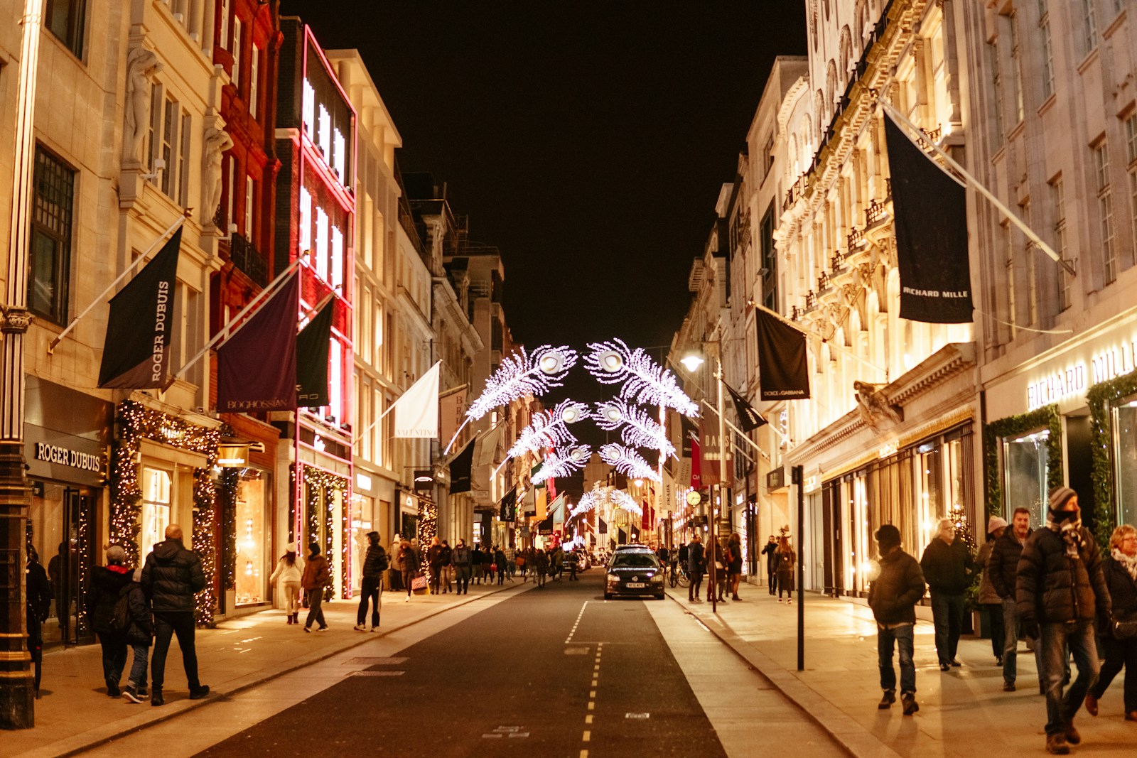 a street with people walking on it and buildings on the side